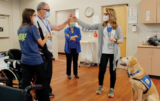 Adult neurologic patient improving fine motor skills through a hand therapy ball exercise